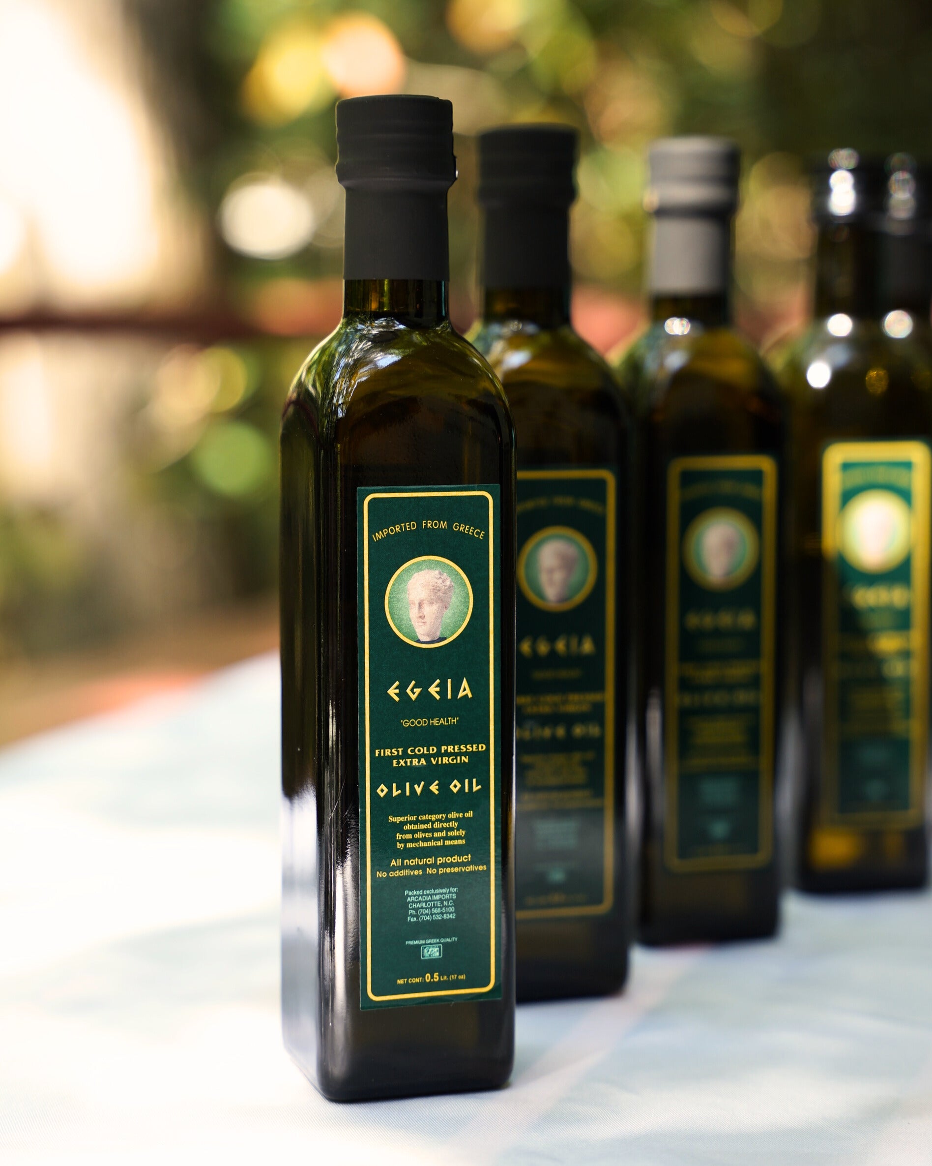 A beautiful setting with Aegean United olive oil bottles on a table, reflecting the essence of Mediterranean cuisine and tradition